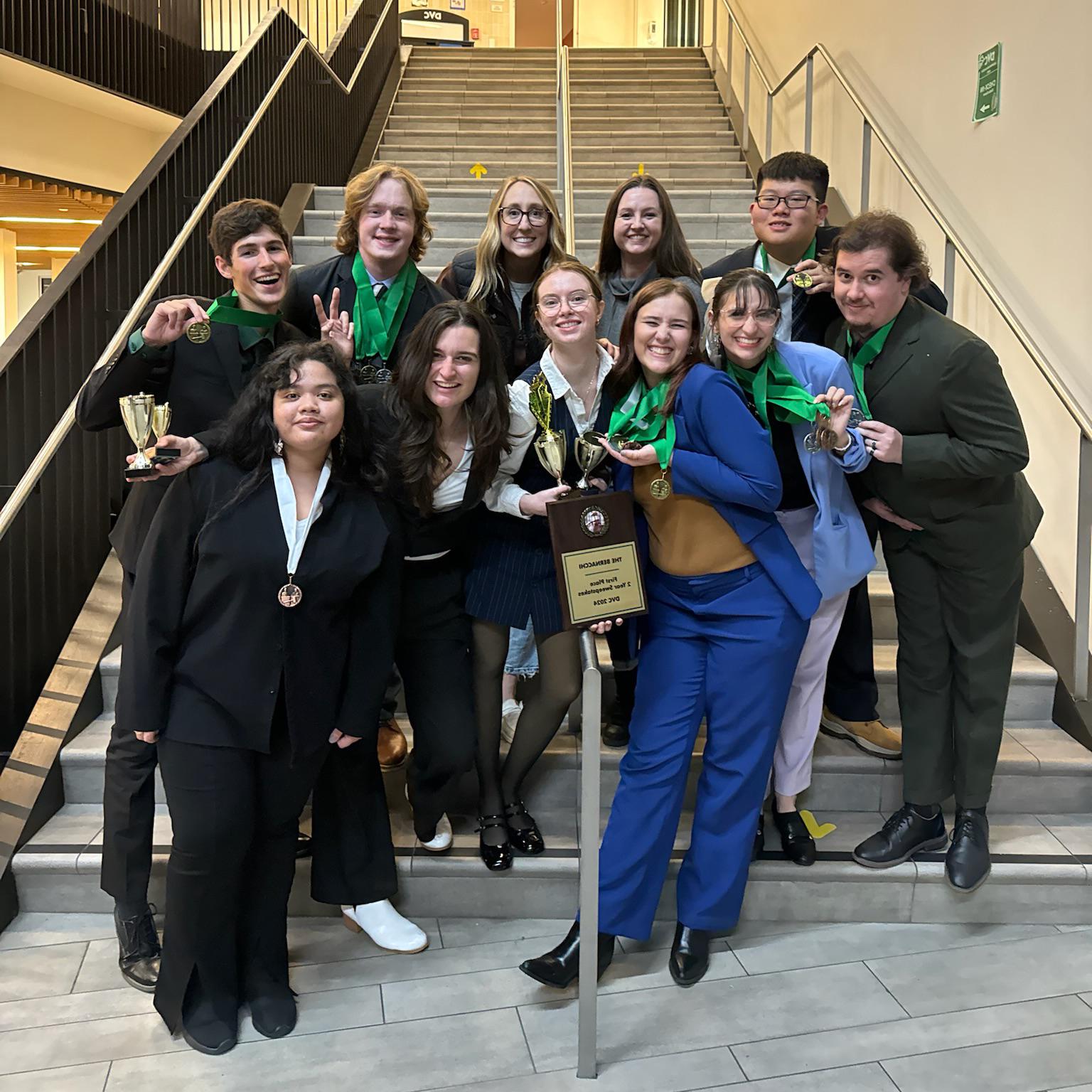 The Butte College Speech and Debate team poses together with their awards.